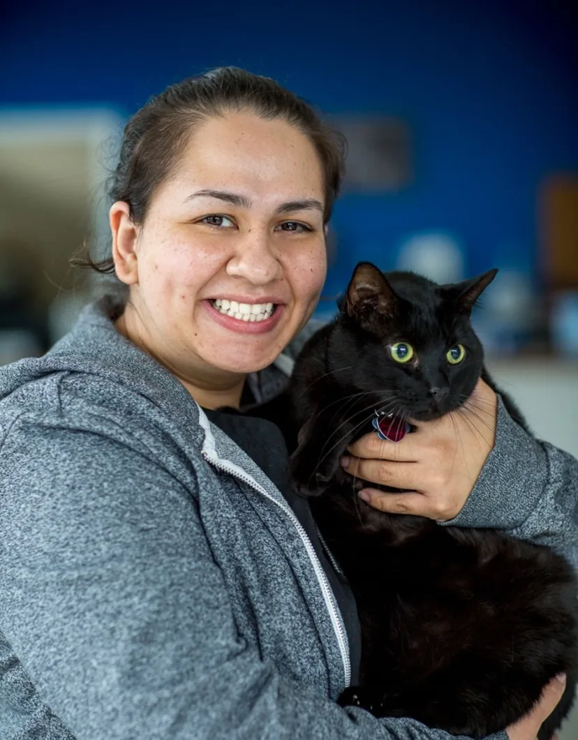 Theresa holding black cat at Tacoma Animal Hospital